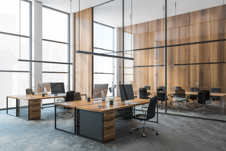 Modern open-plan office space with sleek furniture and wood accents