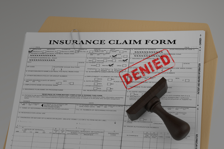 Insurance claim form stamped with 'Denied' in red ink