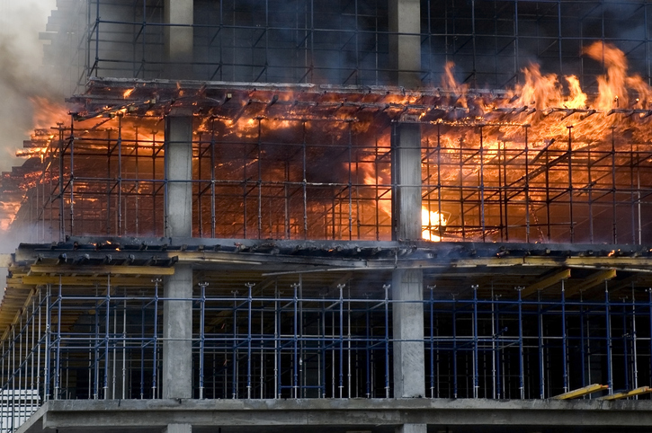 Construction site engulfed in flames, demonstrating fire safety risks.