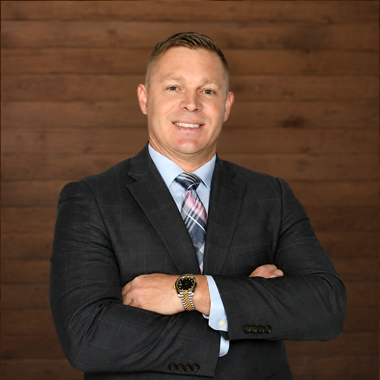 Confident businessman in a suit against wooden wall background